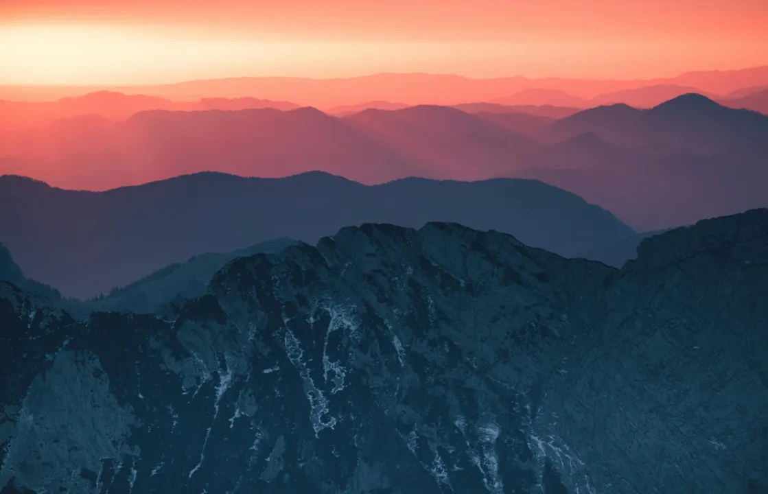 Layered mountain range at sunset