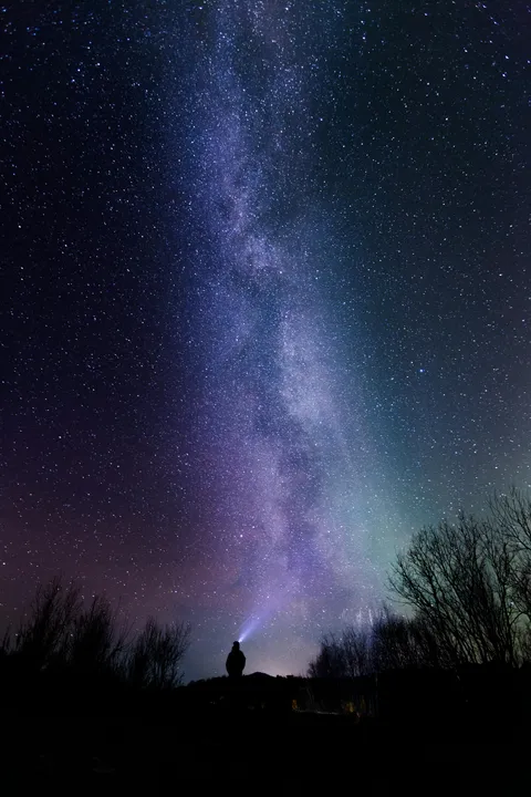 Milky Way with person and flashlight