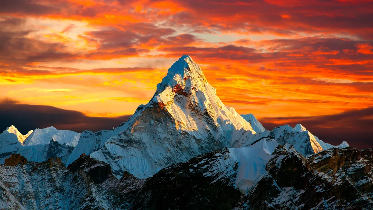 Snowy mountain peak at sunset